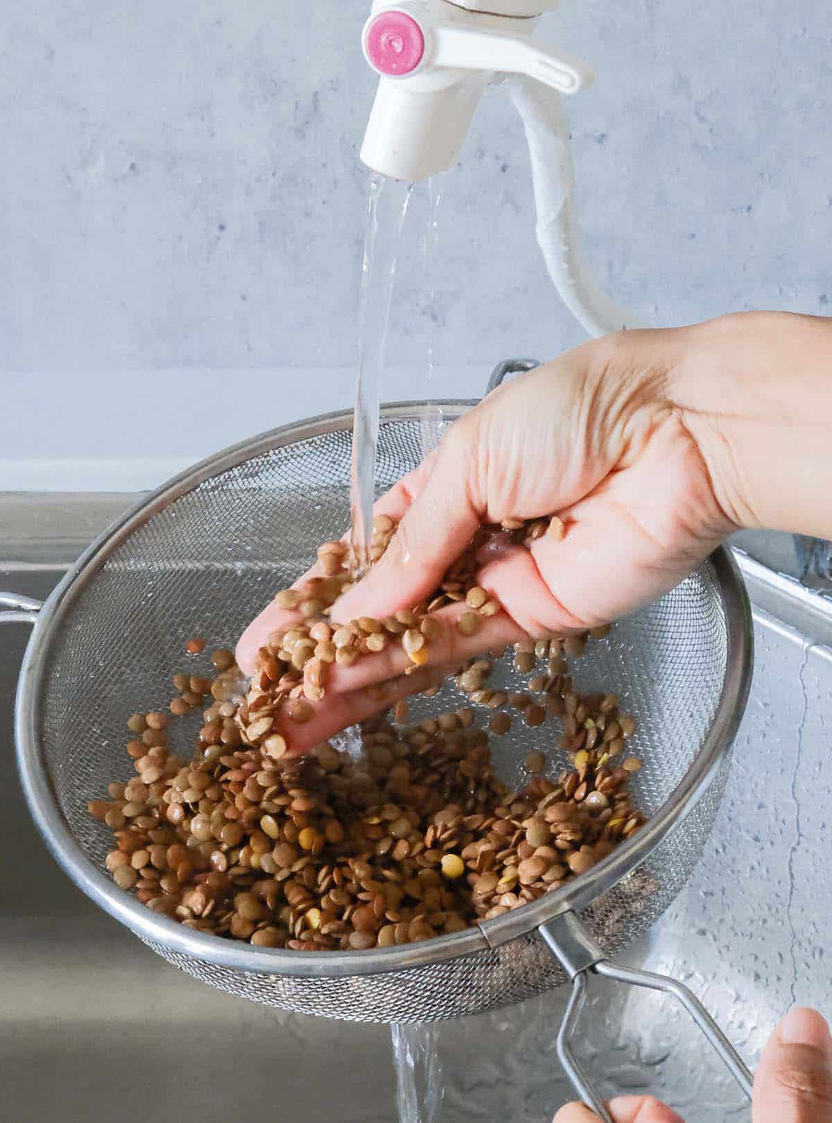 Washing lentils in a strainer