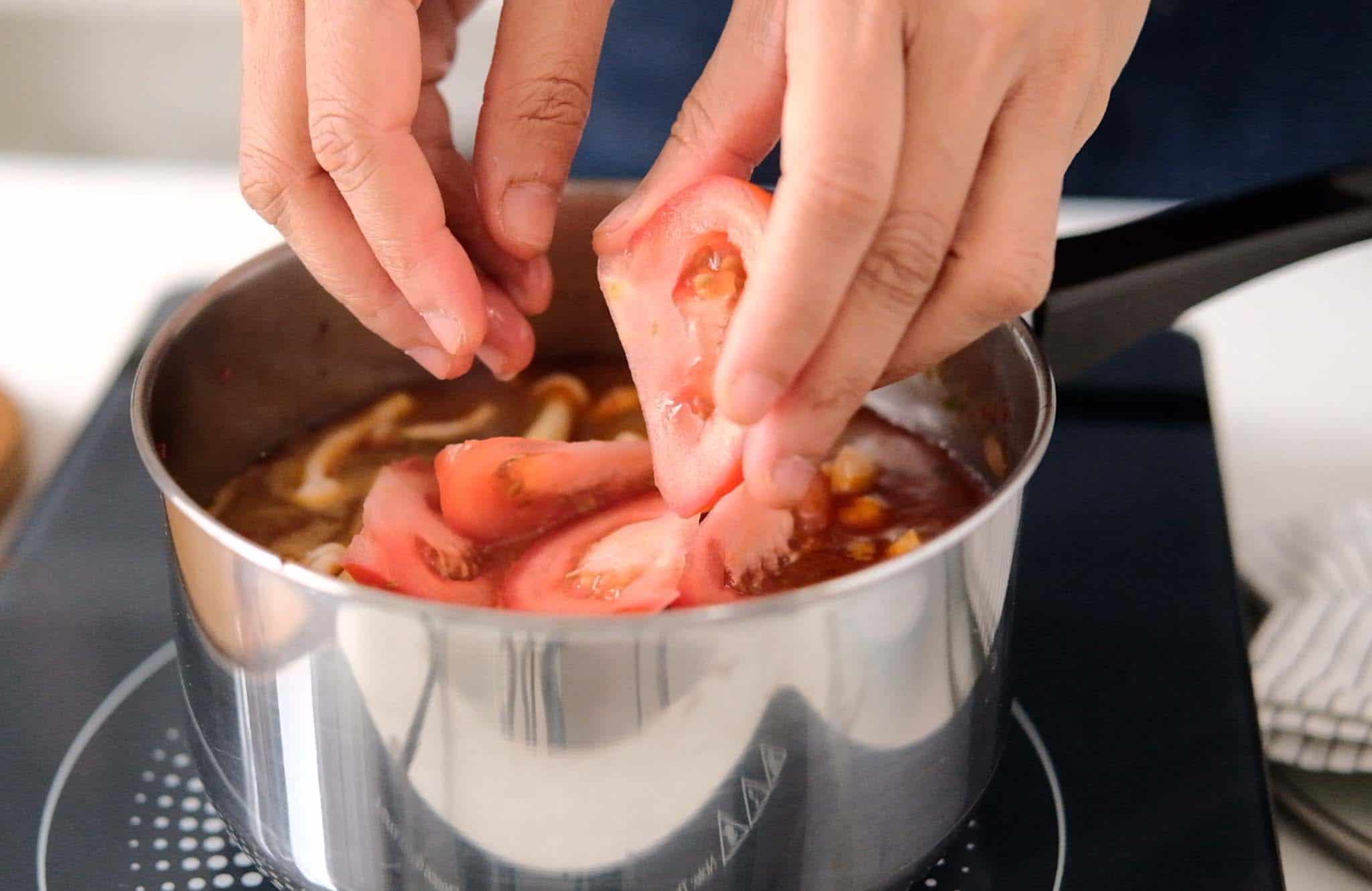 Step 6_How to make tom yum chicken_Add tomato & mushrooms & cook for 3 to 5 minutes