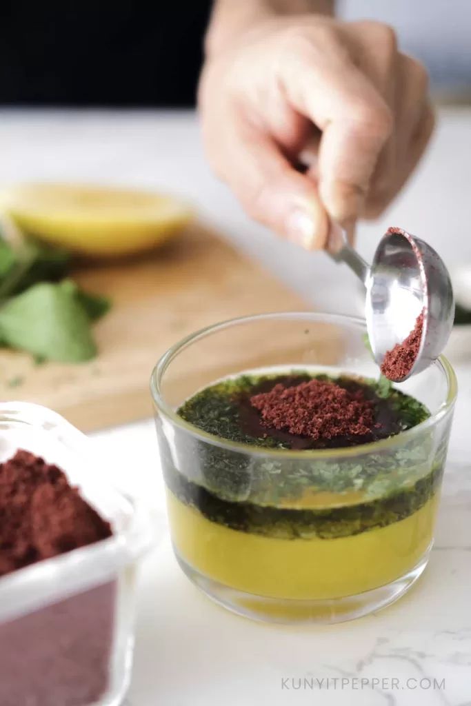 Adding sumac into the mixture to make sumac sauce