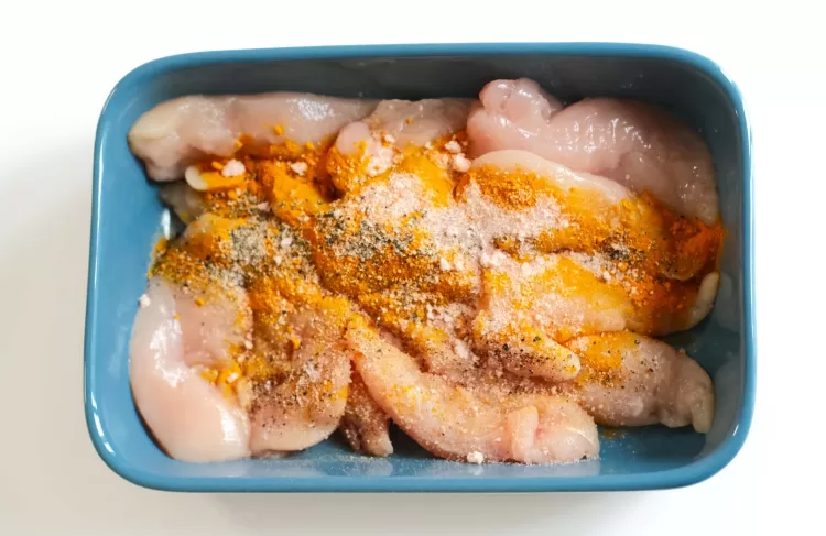 Step 1 on how to make turmeric and black pepper chicken : Marinate the chicken with seasonings