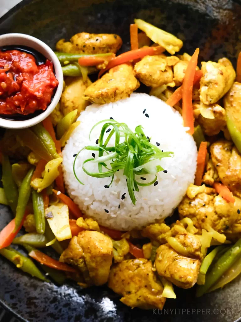 Top View of Turmeric Chicken With Rice and Sambal