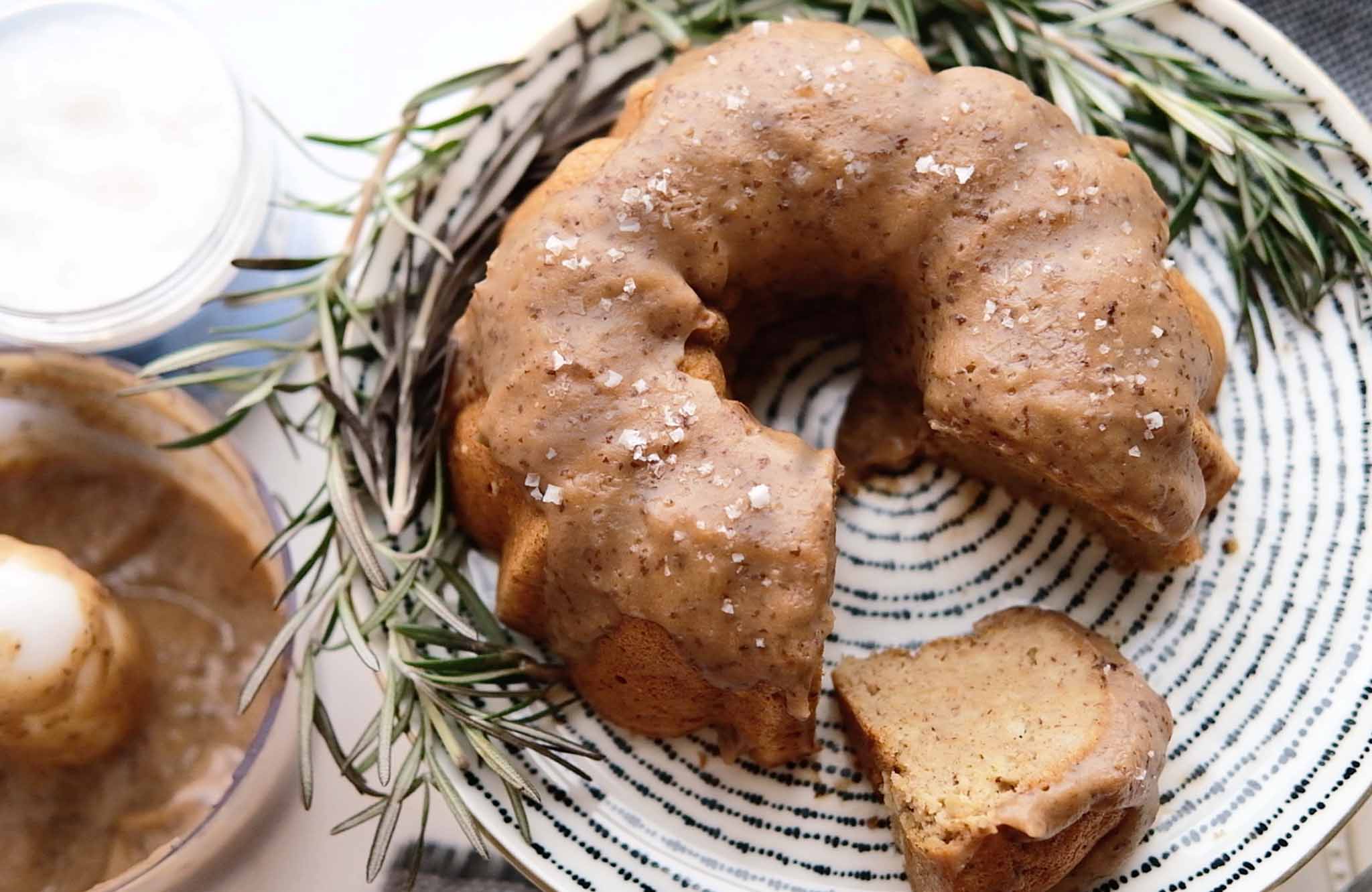 Gingerbread bundt cake in a dish next to the date caramel topping.
