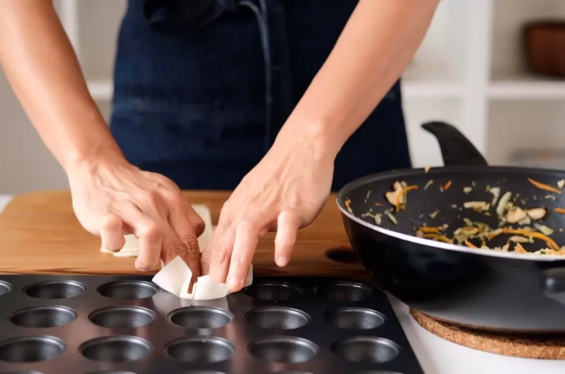 Place each phyllo sheet on top of the pan hole and press it into the hole with fingers
