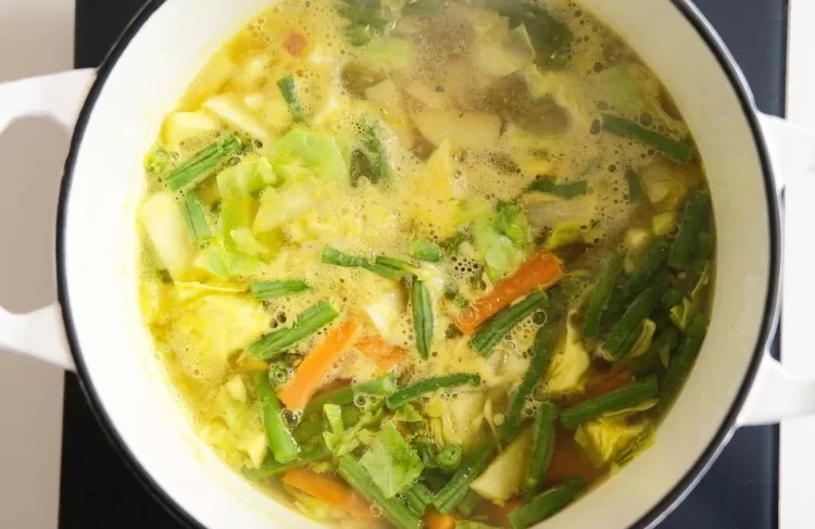 Mixed veges with broth boiling in a pot