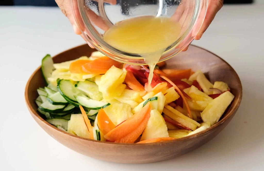 Pour vinaigrette 
mixture into the salad bowl