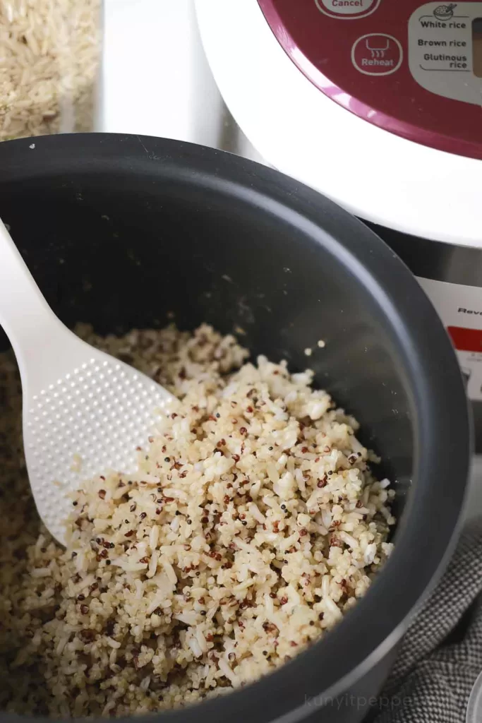 Cooked quinoa and brown rice in rice cooker pot