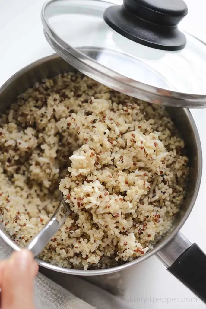 Cooked quinoa and brown rice in a saucepan