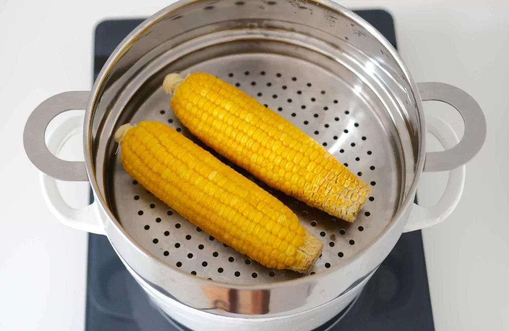 Steamed corn in a steamer