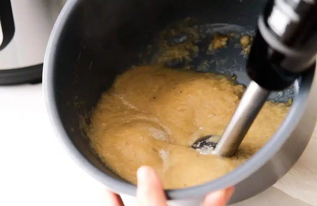 Blending the softened pears with immersion blender until smooth