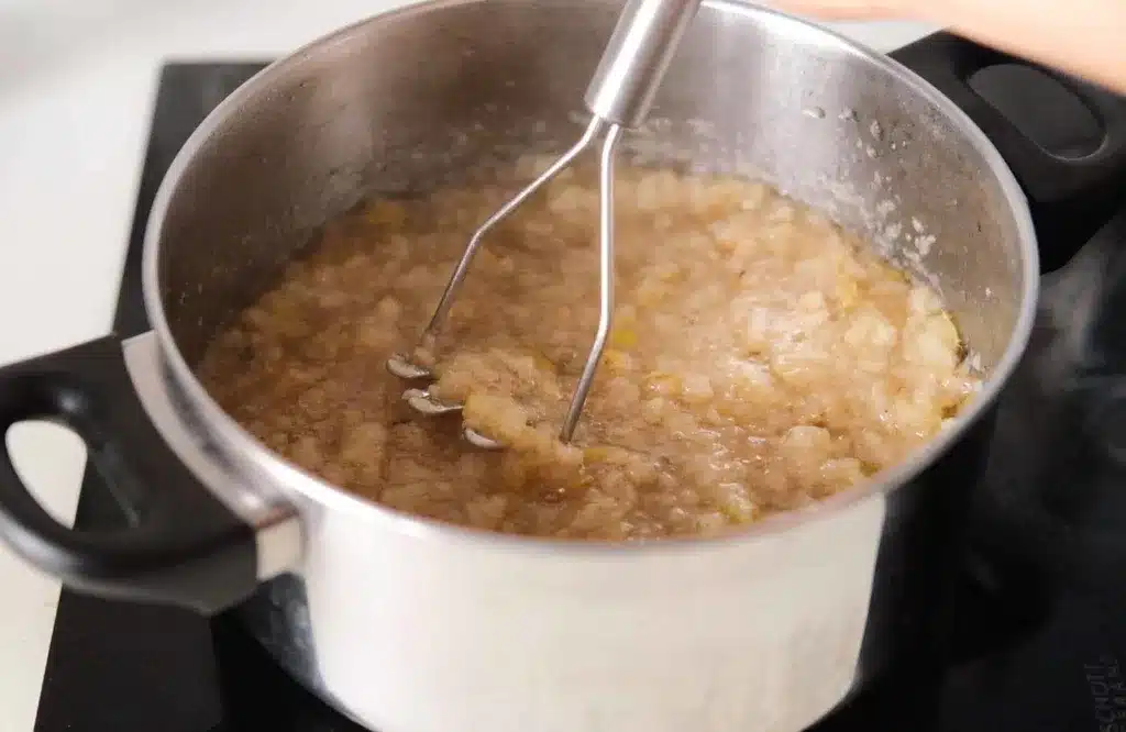 Cooked pear mashed with potato masher