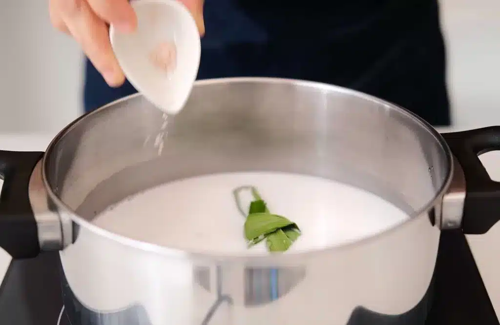 Cooking bubur cha cha broth in a pot