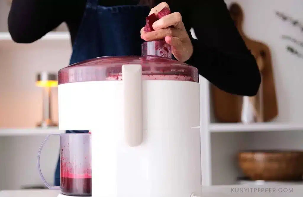 Juicing the fruits to make non-alcoholic red mulled wine