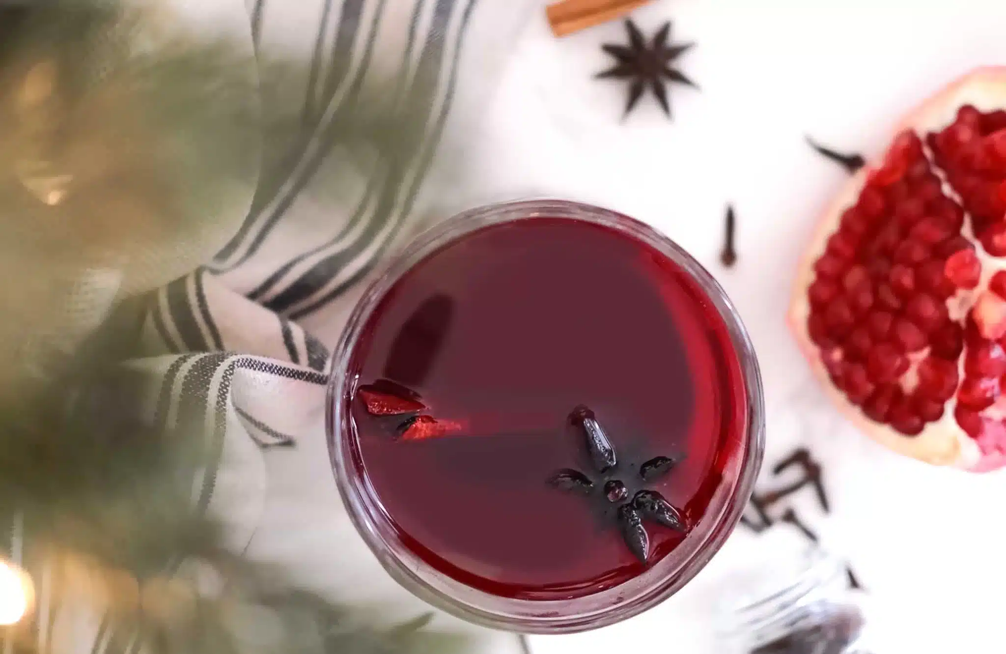 Non-alcoholic Red Mulled Wine view from top next to pomegranate and spices