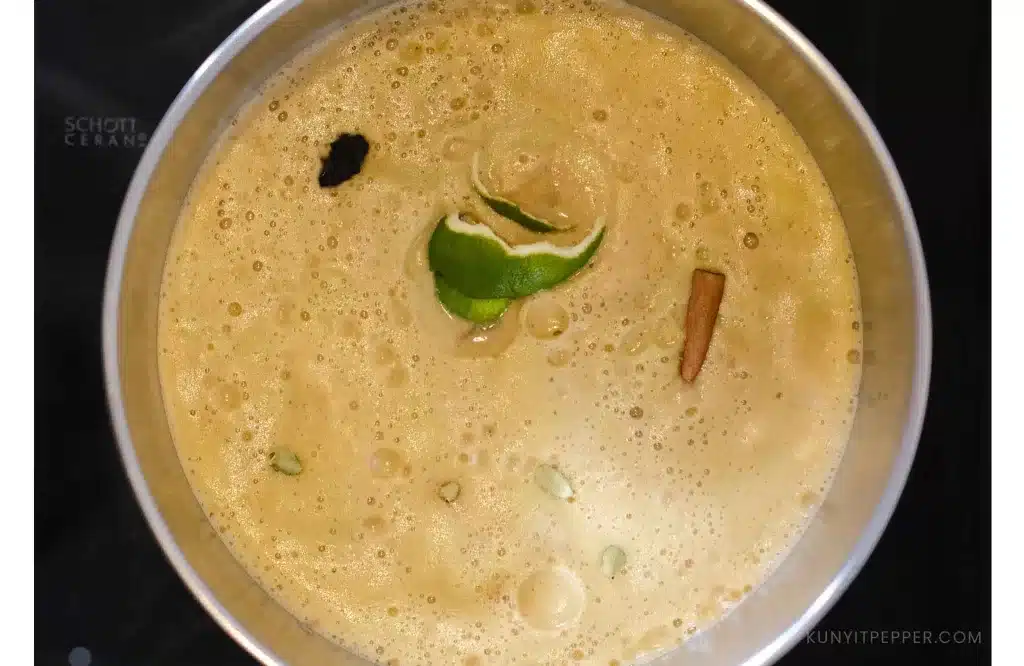 Non-alcoholic white wine ingredients in a pot on a stovetop