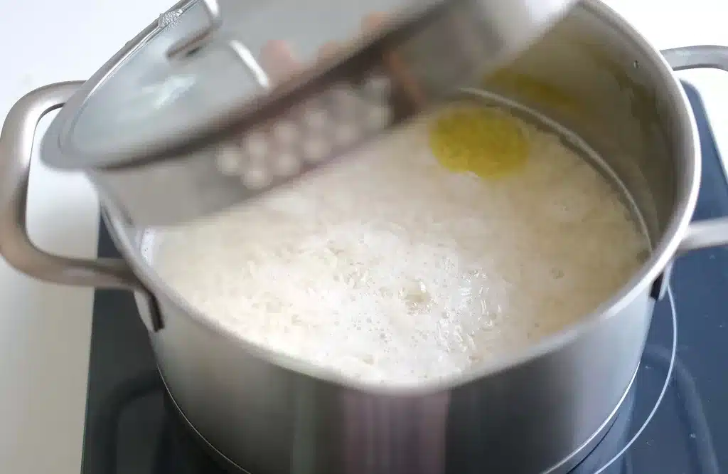 Pre boiling rice to make pomegranate rice