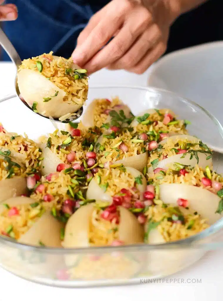 Scooping Pomegranate rice stuffed onion