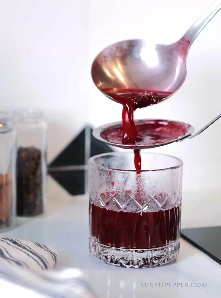 Straining Non-Alcoholic Red Mulled Wine.