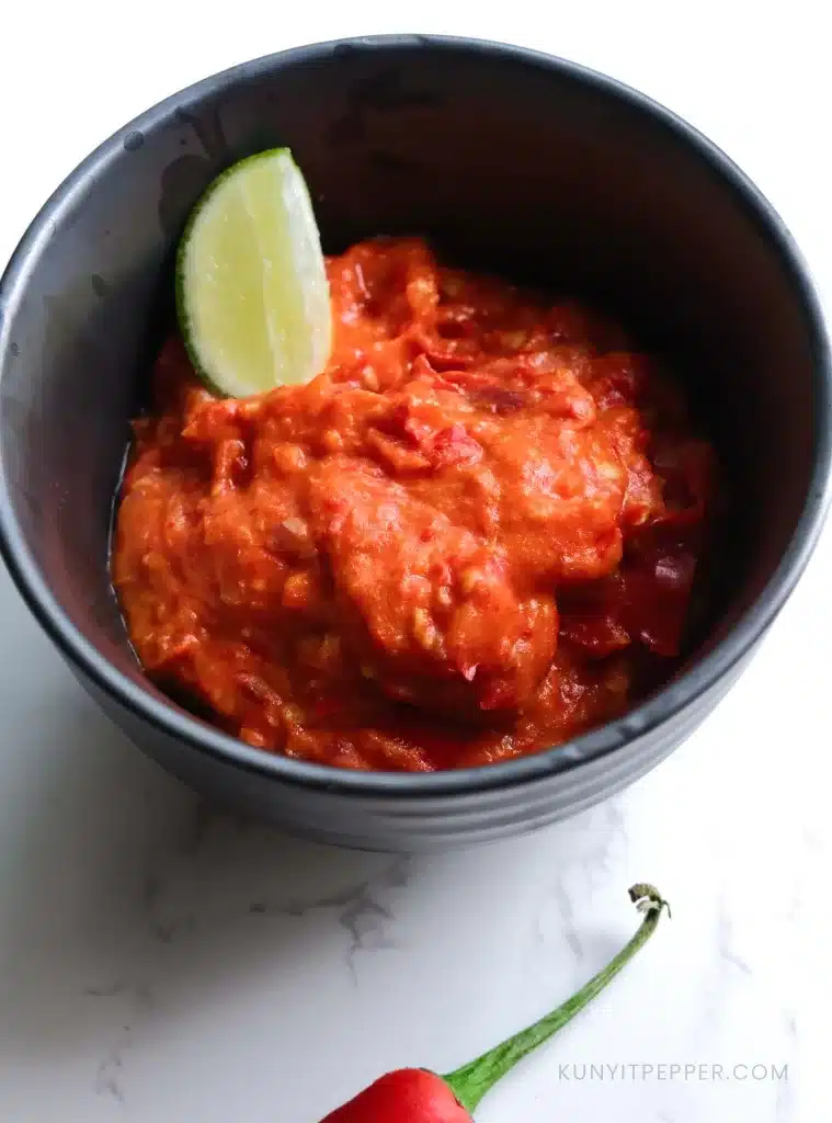 Sambal Ulek or Sambal Oelek in a bowl garnished with key lime