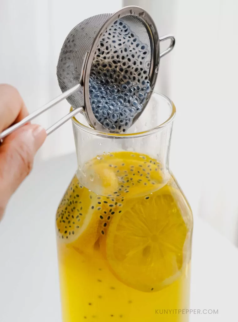 Adding strained soaked basil seeds into drink jar