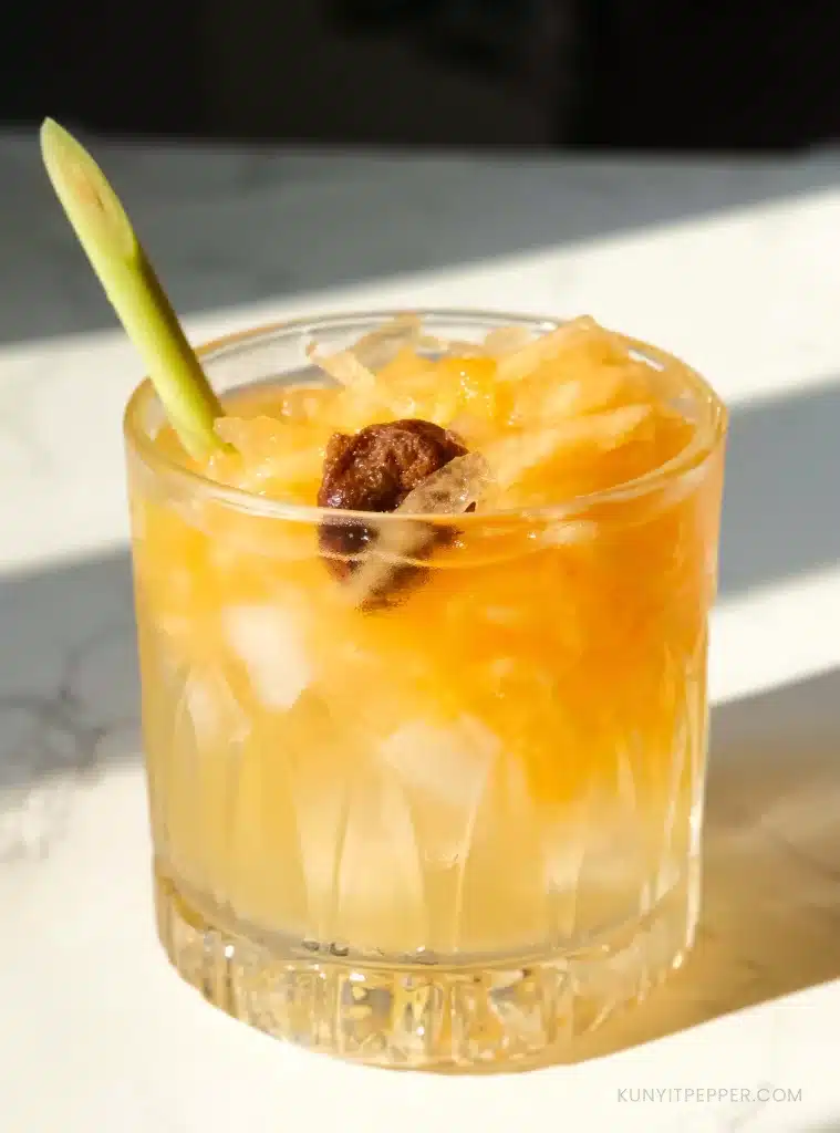 Filipino Cantaloupe Juice with dried plum and lemongrass in a crystal jar