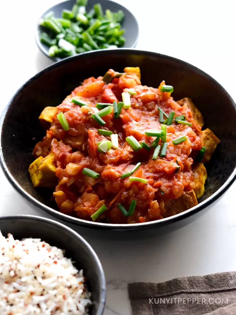 Vietnamese tofu with tomato sauce is a warm and savory, comfort Vietnamese protein dish eaten next to rice.
Known as đậu phụ sốt cà chua in Vietnamese, this dish combines fried tofu with a tomato-rich sauce simmered into a thick, flavor-packed gravy that is mildly sweet, tangy, slightly spicy, and garlicky.
Easy to make in less than 30 minutes, this classic Vietnamese homemade tofu with tomato sauce makes a satisfying main for both lunch and dinner.
PHOTO of it on top of warm rice
Serve it next to warm rice, fresh herbs, and veggies, and you'll have a well-balanced meal.