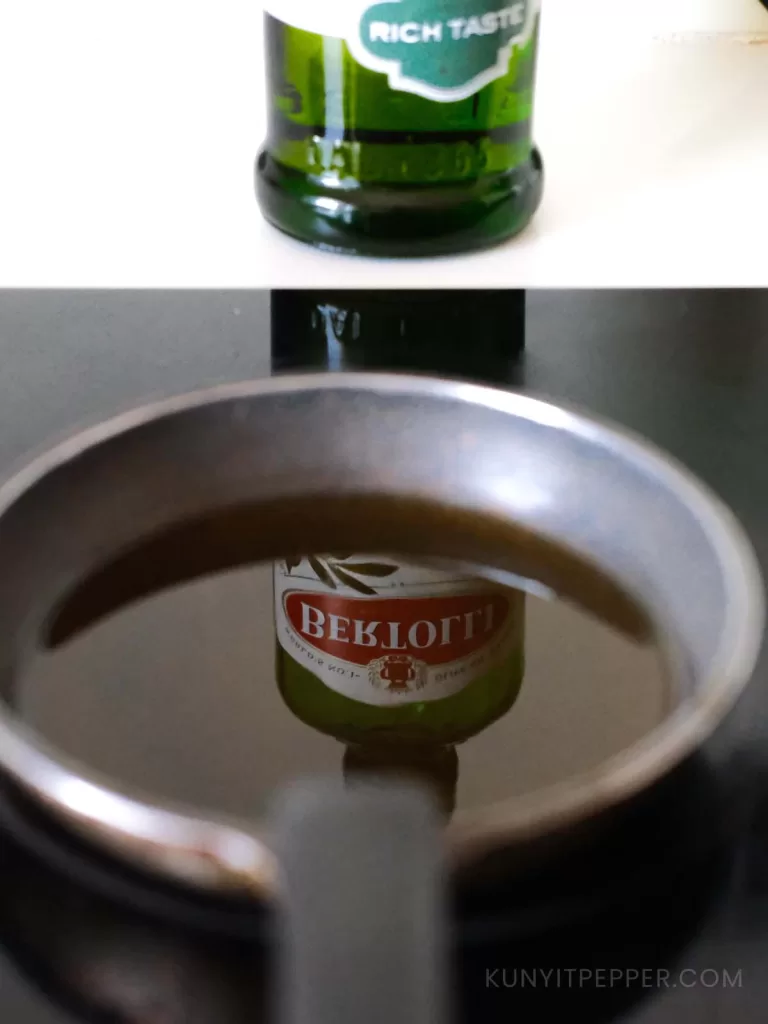 Heating olive oil in a pan on the stovetop - With a reflection of Bertolli olive oil bottle
