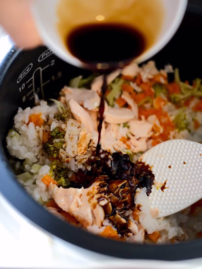 Pouring soy sauce onto the rice and salmon