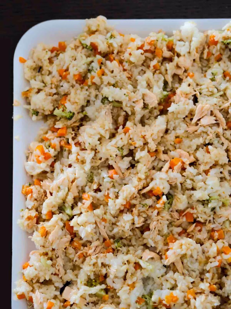 Rice and salmon mixture in a flat tray